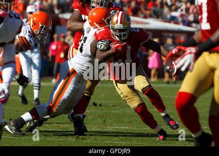 Oct 30, 2011; San Francisco, CA, USA; San Francisco 49ers running back Frank Gore (21) is tackled by Cleveland Browns defensive tackle Ahtyba Rubin (71) during the second quarter at Candlestick Park. San Francisco defeated Cleveland 20-10. Stock Photo