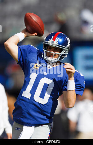 Oct 16, 2011; East Rutherford, NJ, USA; New York Giants quarterback Eli  Manning (10) scrambles out of the pocket past Buffalo Bills defensive  tackle Kellen Heard (72) and inside linebacker Nick Barnett (