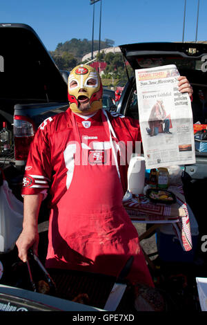 Jan 14, 2012; San Francisco, CA, USA; San Francisco 49ers fan Joe Neto Jr. holds up the front cover of the San Jose Mercury News with a portrait of himself while tailgating before the 2011 NFC divisional playoff game against the New Orleans Saints at Cand Stock Photo