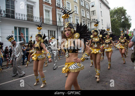 Brazilian dancers take part in the parade on Monday 28th August 2016 at Notting Hill Carnival in West London. A celebration of West Indian / Caribbean culture and Europes largest street party, festival and parade. Revellers come in their hundreds of thousands to have fun, dance, drink and let go in the brilliant atmosphere. It is led by members of the West Indian / Caribbean community, particularly the Trinidadian and Tobagonian British population, many of whom have lived in the area since the 1950s. The carnival has attracted up to 2 million people in the past and centres around a parade of f Stock Photo