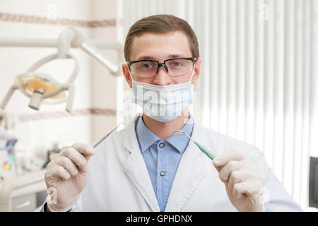 Young dentist with instruments Stock Photo