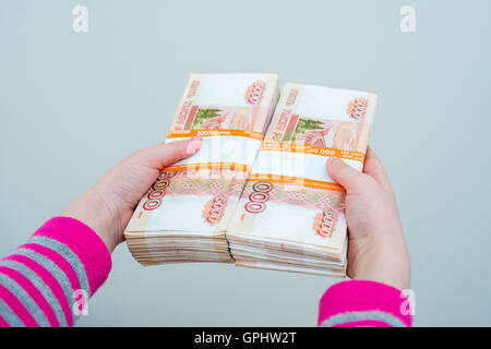 closeup human's hands holding russian rubles Stock Photo