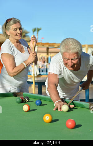 old couple playing billiards Stock Photo