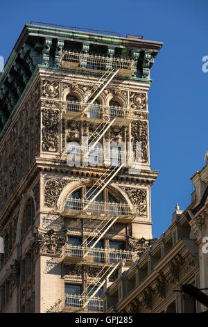 Soho building with intricate facade, terracotta ornamentation, copper cornice and painted iron fire escape. Manhattan, New York Stock Photo