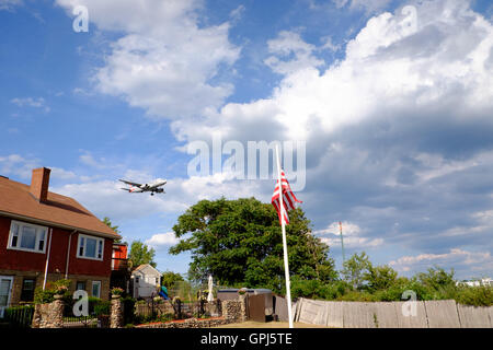 American Airlines jet flying over Orient Heights and about to land at Boston Logan International Airport, USA Stock Photo