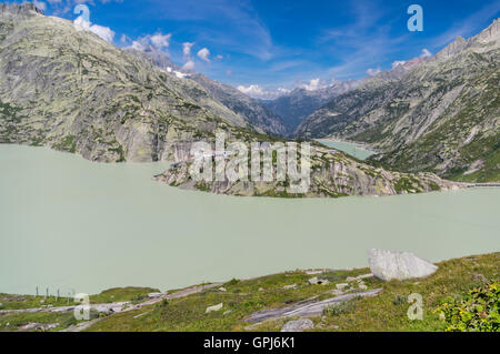 Grimsel Hospiz on a rock over Grimselsee, a hydroelectric reservoir lake in the Swiss Alps. Oberhasli, Switzerland. Stock Photo