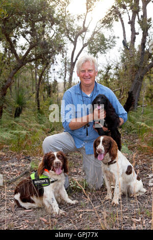 Dog trainer, Steve Austin with feral animal detection dog, Bolt. Black Rock National Park, NSW, Australia Stock Photo