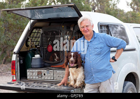 Dog trainer, Steve Austin with feral animal detection dog, Bolt. Black Rock National Park, NSW, Australia Stock Photo