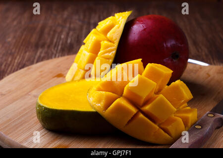 Fresh mango organic product on wooden background Stock Photo