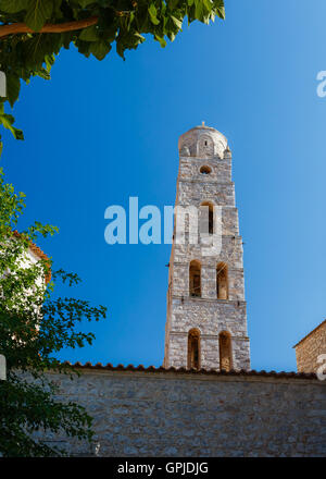 Traditional white bell tower against a blue sky at Areopolis town in Lakonia, Greece Stock Photo