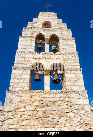 Traditional white bell tower against a blue sky at Areopolis town in Lakonia, Greece Stock Photo