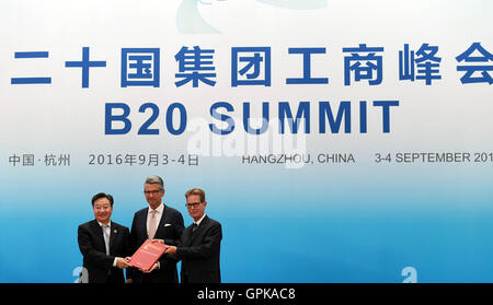 Hangzhou, China's Zhejiang Province. 4th Sep, 2016. Jiang Zengwei (L), chair of the Business 20 (B20) China and also chairman of the China Council for the Promotion of International Trade, hands over a document to the representatives of the next B20 summit host Ulrich Grillo (C), president of the Federation of German Industries, and Gerhard Braun, vice-president of Confederation of German Employers' Associations, in Hangzhou, capital of east China's Zhejiang Province, Sept. 4, 2016. The B20 summit concluded in Hangzhou on Sunday. © Chen Yehua/Xinhua/Alamy Live News Stock Photo