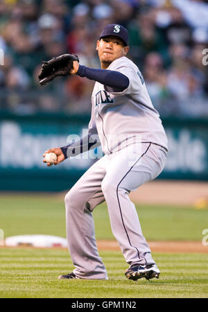 April 5, 2010; Oakland, CA, USA;  Seattle Mariners second baseman Jose Lopez (4) throws to first base against the Oakland Athletics during the first inning at Oakland-Alameda County Coliseum. Seattle defeated Oakland 5-3. Stock Photo