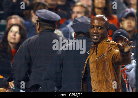 June 22, 2011; San Francisco, CA, USA;  Former San Francisco Giants outfielder Barry Bonds (right) waves to fans while being escorted through the stands by two police officers during the seventh inning between against the Minnesota Twins at AT&T Park. Stock Photo