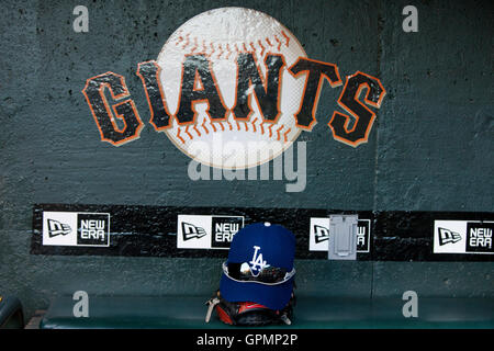 September 15, 2010; San Francisco, CA, USA;  A Los Angeles Dodgers hat and glove sits in the visitors dugout before the game against the San Francisco Giants at AT&T Park. Stock Photo