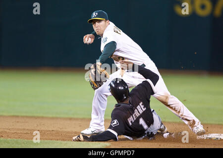 September 21, 2010; Oakland, CA, USA;  Oakland Athletics shortstop Cliff Pennington (2) throws over Chicago White Sox left fielder Juan Pierre (1) to complete a double play during the eighth inning at Oakland-Alameda County Coliseum. Oakland defeated Chic Stock Photo