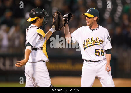 September 21, 2010; Oakland, CA, USA;  Oakland Athletics relief pitcher Craig Breslow (56) celebrates with catcher Kurt Suzuki (8) after the game against the Chicago White Sox at Oakland-Alameda County Coliseum. Oakland defeated Chicago 7-2. Stock Photo