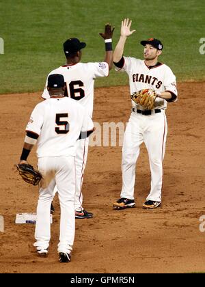 Oct 28, 2010; San Francisco, CA, USA; San Francisco Giants infielders Juan Uribe (5) and Edgar Renteria (16) and Freddy Sanchez (right) celebrate after game two of the 2010 World Series against the Texas Rangers at AT&T Park. The Giants won 9-0. Stock Photo