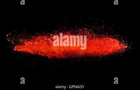 Explosion of red powder, isolated on black background Stock Photo