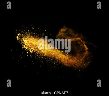 Explosion of yellow powder, isolated on black background Stock Photo