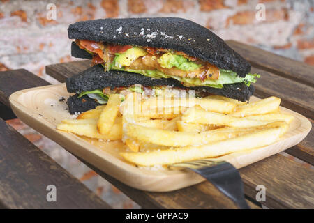 charcoal bread with guacamole bacon and tomato sanwich Stock Photo