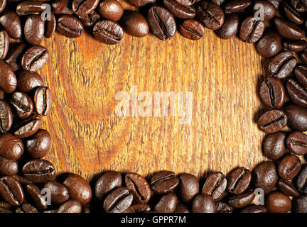 Coffee beans stacked in a frame on a wooden background Stock Photo