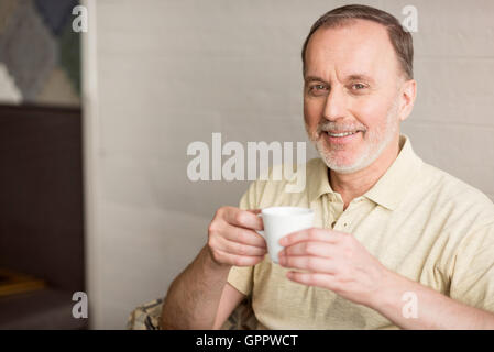 Cheerful senior man drinking coffee Stock Photo