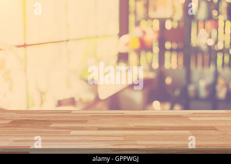 Empty wood table and Blurred background display at coffee shop with space for product. Stock Photo