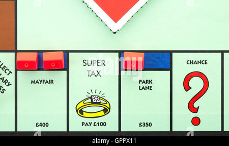 Monopoly board game showing Super Tax Pay £100, The classic trading ...