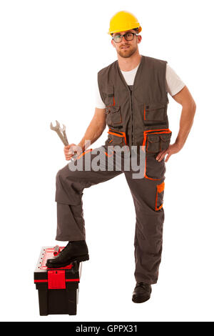 Happy Worker standing on Toolkit And holding  Wrench Over White Stock Photo