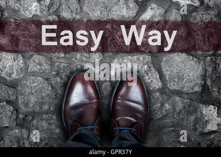 Easy Way message on asphalt and business shoes Stock Photo