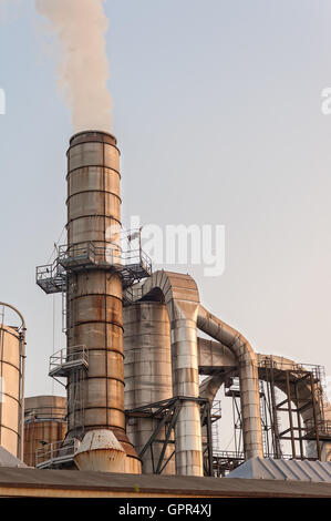 Chemical plant at sunset. Silos and smokestacks of a factory Stock ...