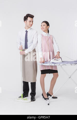 Harmonious young couple doing chores Stock Photo