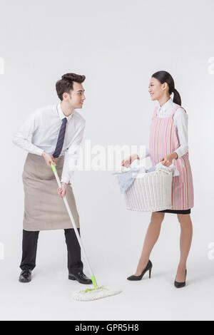 Young harmonious couple doing chores Stock Photo