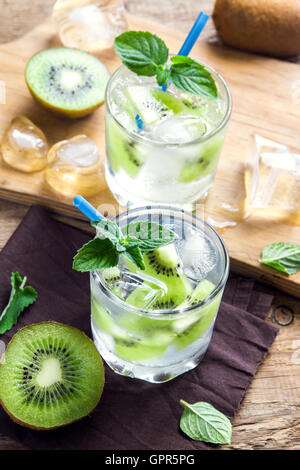 Kiwi drink (cocktail) with mint and ice in glasses close up Stock Photo