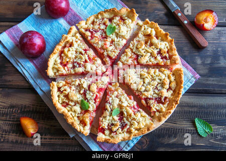 Homemade shortcrust plum cake with crumble on wooden background Stock Photo