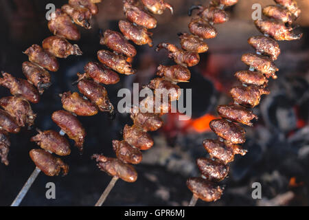 Churrasco, traditional Brazilian barbecue, chicken hearts grilled kebabs. Stock Photo