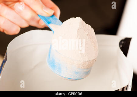 Plastic Measuring Scoop Of White Powder Whey Protein Against Grunge Wood  Background Stock Photo, Picture and Royalty Free Image. Image 13746751.