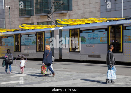 Metrolink new tram station, transport, transportation, travel, train, city, railway, rail, public, urban, railroad, vehicle, road, traffic, street, modern, people, passenger, speed, metro, tramway, tourism, icon, electric, architecture at Exchange Square, Manchester, UK Stock Photo