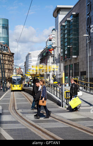 Metrolink new tram station, transport, transportation, travel, train, city, railway, rail, public, urban, railroad, vehicle, road, traffic, street, modern, people, passenger, speed, metro, tramway, tourism, icon, electric, architecture at Exchange Square, Manchester, UK Stock Photo