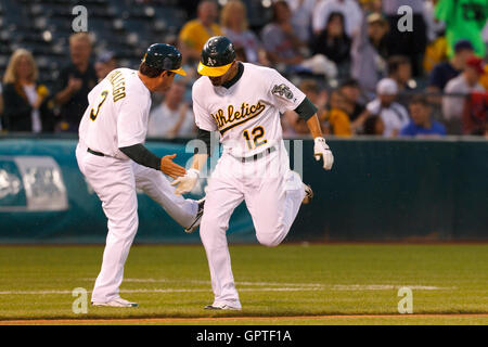 Apr 18, 2002; Oakland, CA, USA; Oakland Athletics' Jeremy Giambi, #7,  receives congratulations from third base coach Ron Washington, #38, after  hitting a solo homerun in the sixth inning of their game