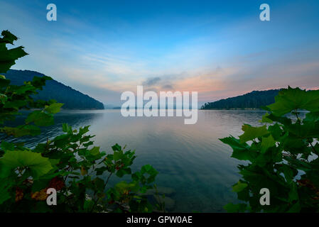 An amazing sunrise over Cave Run Lake in the Daniel Boone National Forest. Captured at Windy Bay Fishing Point. Stock Photo