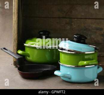 set of metal pots cookware on a wooden, domestic kitchen Stock Photo