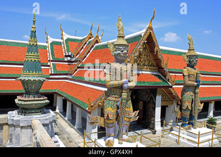 Wat Phra Kaew gate is guarded by a pair of yakshas statues, mythical giants measuring 5 metres (16 ft) high. Grand Palace Bangkok Thailand Stock Photo