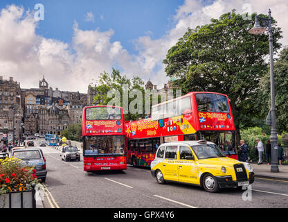 Sightseeing buses and a yellow taxi on Waverley Bridge, Edinburgh, with a view to the Old Town, Edinburgh, Scotland, UK Stock Photo