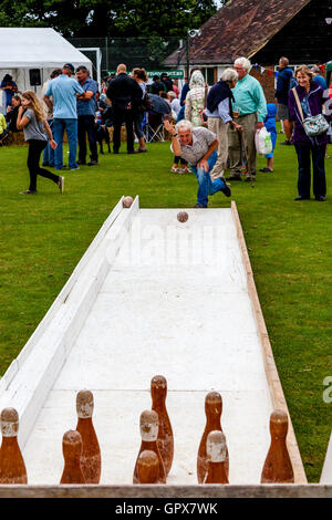 People Playing Skittles At The Annual Hartfield Village Fete, Alfriston, East Sussex, UK Stock Photo