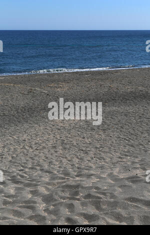 The Kamari beach with black volcanic stones at Santorini island, Greece Stock Photo