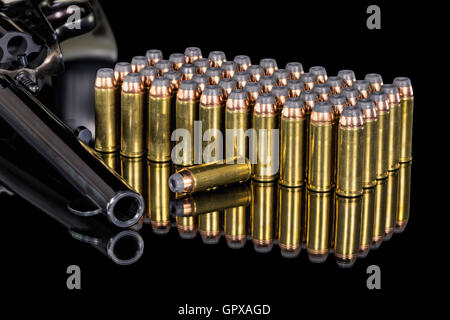 Pistol with ammunition on a black reflective surface Stock Photo
