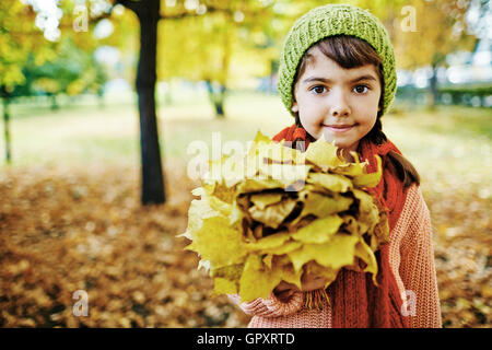 Small Girl with Maple Leaves Bouquet Stock Photo