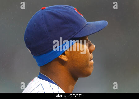 May 14, 2011; Chicago, IL, USA;  Chicago Cubs shortstop Starlin Castro (13) stands in the rain during the national anthem before the game against the San Francisco Giants at Wrigley Field.  San Francisco defeated Chicago 3-0 in a rain shortened game. Stock Photo